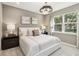 Comfortable bedroom with neutral tones, a large window, and decorative bedside lamps at 5228 Luisa Ct, St Cloud, FL 34771