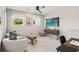 Bedroom with two cozy chairs, modern TV, and unique side table creates a relaxing and inviting space at 5228 Luisa Ct, St Cloud, FL 34771