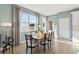 Bright dining room featuring a wood table, seating for six, and large windows offering natural light at 5228 Luisa Ct, St Cloud, FL 34771