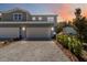 Charming townhome featuring a brick driveway, two-car garage, and manicured landscaping at 5228 Luisa Ct, St Cloud, FL 34771
