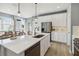 Stylish kitchen featuring stainless appliances, white cabinets, and a spacious island with bar seating at 5228 Luisa Ct, St Cloud, FL 34771