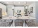 Modern kitchen with white cabinets, stainless appliances, and a spacious island with seating at 5228 Luisa Ct, St Cloud, FL 34771