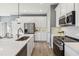 Bright kitchen with stainless appliances, island sink, and modern lighting fixtures at 5228 Luisa Ct, St Cloud, FL 34771
