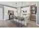Modern kitchen featuring white cabinets, stainless steel appliances, and a large island with seating at 5228 Luisa Ct, St Cloud, FL 34771