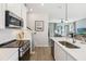 Modern kitchen features stainless steel appliances, white cabinets, and an island with a sink at 5228 Luisa Ct, St Cloud, FL 34771
