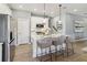 Modern kitchen with white cabinetry, stainless steel appliances, a large island, and stylish lighting at 5228 Luisa Ct, St Cloud, FL 34771