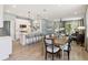 Open-concept living space with kitchen island, modern appliances, dining area, and cozy living room at 5228 Luisa Ct, St Cloud, FL 34771