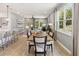 Open-concept living space with kitchen island, dining area, cozy living room, and large windows at 5228 Luisa Ct, St Cloud, FL 34771