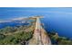 Breathtaking aerial view of a scenic bridge and lake, surrounded by natural beauty and lush greenery at 5289 Luisa Ct, St Cloud, FL 34771