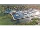 Overhead shot of marina with many boats docked in slips, adjacent to a building and waterway at 5289 Luisa Ct, St Cloud, FL 34771
