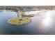 Scenic aerial view of a waterfront park with a gazebo and walking path on a sunny day at 5289 Luisa Ct, St Cloud, FL 34771