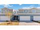 Charming townhome featuring a two-car garage, a light blue painted exterior, and manicured landscaping at 5289 Luisa Ct, St Cloud, FL 34771