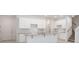 Bright kitchen with white cabinets, granite countertops, a center island, and stainless steel appliances at 5289 Luisa Ct, St Cloud, FL 34771