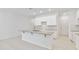 Bright kitchen with white cabinets, granite countertops, a center island, and stainless steel appliances at 5289 Luisa Ct, St Cloud, FL 34771