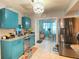 Bright kitchen featuring stainless steel appliances and sleek turquoise cabinets at 10867 Sw 83Rd Ct, Ocala, FL 34481