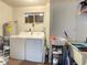 Functional laundry room with washer, dryer, and utility sink at 10867 Sw 83Rd Ct, Ocala, FL 34481