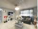 Living room with tile flooring, modern decor, and a TV setup at 10867 Sw 83Rd Ct, Ocala, FL 34481