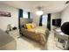 Comfortable bedroom with a tiled floor, ceiling fan, and a stylish headboard at 10867 Sw 83Rd Ct, Ocala, FL 34481