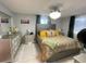 Comfortable bedroom with a tiled floor, ceiling fan, and a stylish headboard at 10867 Sw 83Rd Ct, Ocala, FL 34481