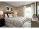 Inviting bedroom featuring a comfortable bed, neutral decor, and natural light from the window at 5000 Balsam Falls Rd, Deland, FL 32724