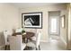 Charming dining area with seating for four, accentuated by a striking horse art piece at 5000 Balsam Falls Rd, Deland, FL 32724