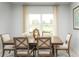 Bright dining room featuring a wooden table, comfortable seating, and a picturesque window view at 5012 Bear Lake Loop, Deland, FL 32724