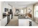 Bright, modern kitchen with granite island, white cabinets, and stainless appliances open to the dining area at 5056 Bear Lake Loop, Deland, FL 32724