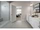 Modern bathroom featuring a tiled shower and vanity with double sinks and plenty of natural light at 11026 Nellie Crossing Cir, Clermont, FL 34711