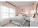 Charming bedroom with a large window providing natural light and neutral, soft pink walls at 11026 Nellie Crossing Cir, Clermont, FL 34711