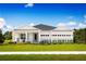 Charming one-story home with a well-manicured lawn, white trim, and a two-car garage at 11026 Nellie Crossing Cir, Clermont, FL 34711
