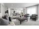 Bright living room with stylish furniture, modern decor, and sliding glass doors to the outside at 11026 Nellie Crossing Cir, Clermont, FL 34711