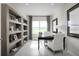 Cozy office space featuring built-in shelving, a desk, and a large window with natural light at 11026 Nellie Crossing Cir, Clermont, FL 34711