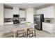 Stylish kitchen with white cabinets, stainless steel appliances, granite countertops and eat-in island at 5035 Bear Lake Loop, Deland, FL 32724
