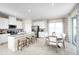 Open-concept kitchen with stainless appliances, island seating, and view to dining area at 5035 Bear Lake Loop, Deland, FL 32724