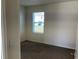 Cozy bedroom with plush carpeting and natural light from a window at 1707 Jindo Dr, Lake Alfred, FL 33850