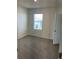 A bedroom with carpet, one window and a door at 1707 Jindo Dr, Lake Alfred, FL 33850