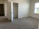 Bright bedroom with carpet, a window, and a closet for organized living at 1707 Jindo Dr, Lake Alfred, FL 33850