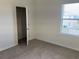 Bedroom featuring neutral carpet, window and closet at 1707 Jindo Dr, Lake Alfred, FL 33850
