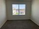 Carpeted bedroom with window showing neighborhood at 1707 Jindo Dr, Lake Alfred, FL 33850