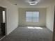 Spacious bedroom with plush carpet, a large window, and neutral-toned walls at 1707 Jindo Dr, Lake Alfred, FL 33850