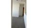 Upstairs hallway featuring neutral walls and carpet providing smooth transition to the home's living spaces at 1707 Jindo Dr, Lake Alfred, FL 33850