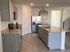 Bright open kitchen with island, granite countertops, and stainless steel appliances at 1707 Jindo Dr, Lake Alfred, FL 33850