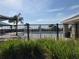 Beautiful community pool area framed by palm trees and lush green plants at 1707 Jindo Dr, Lake Alfred, FL 33850