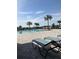 Relaxing poolside with lounge chairs and inviting community swimming pool at 1707 Jindo Dr, Lake Alfred, FL 33850