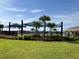 Community pool area with palm trees and shaded seating for outdoor relaxation at 1707 Jindo Dr, Lake Alfred, FL 33850