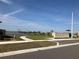 Scenic community streetscape featuring lake views, landscaping and centralized mailbox at 1707 Jindo Dr, Lake Alfred, FL 33850