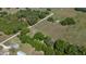 Picturesque land with home, mature trees, and winding driveway, offering a serene and private setting at 3815 Se 25Th St, Bushnell, FL 33513