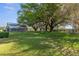 This property features a large backyard with mature trees, a barn, and a playhouse at 3815 Se 25Th St, Bushnell, FL 33513