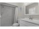 Bathroom features a vanity, large mirror, and walk-in shower with marble tile at 3815 Se 25Th St, Bushnell, FL 33513