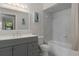 Bathroom features a vanity with double sinks, a large mirror and a tub with marble tile at 3815 Se 25Th St, Bushnell, FL 33513